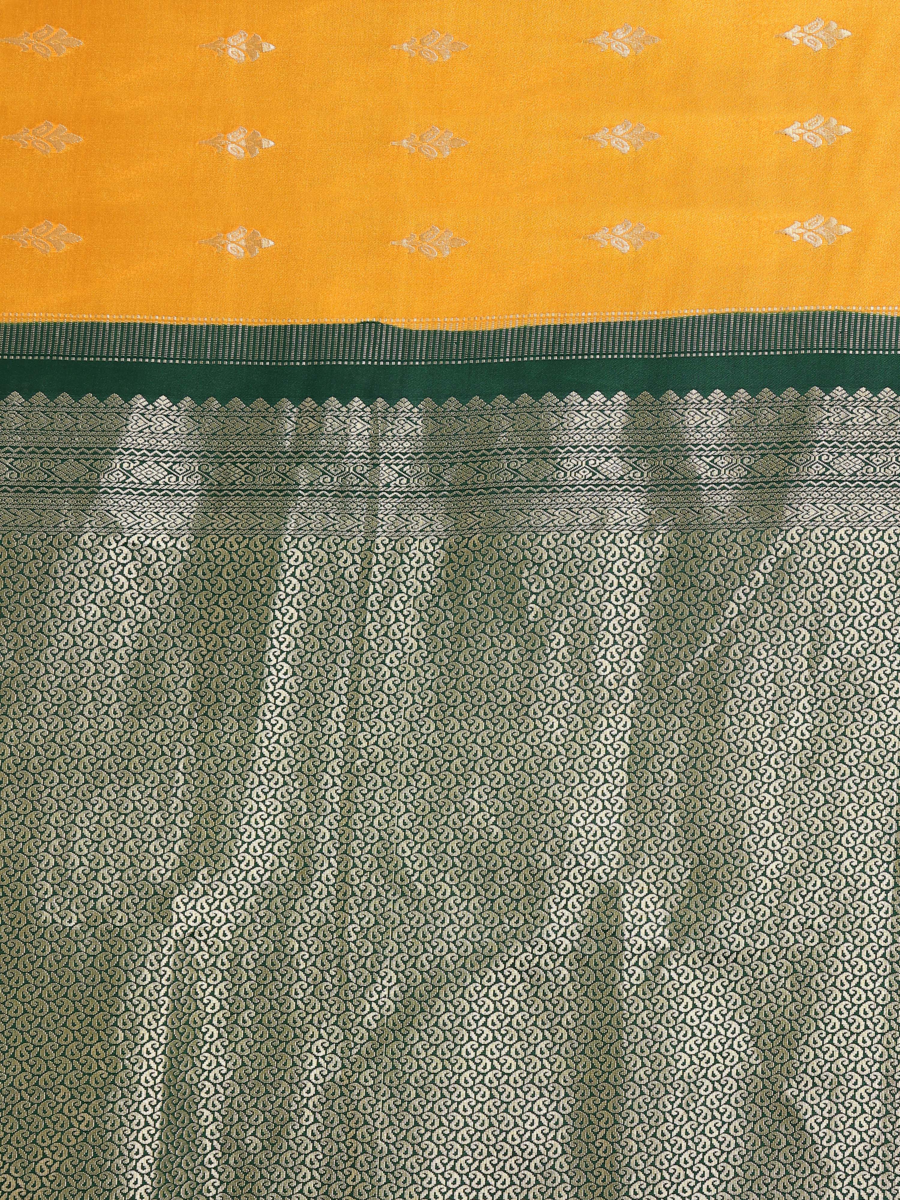 Close up of mango yellow body with two-tone silver gold zari floral bouquet buttas and deep forest green near-fully worked silver paisley jaal pallu