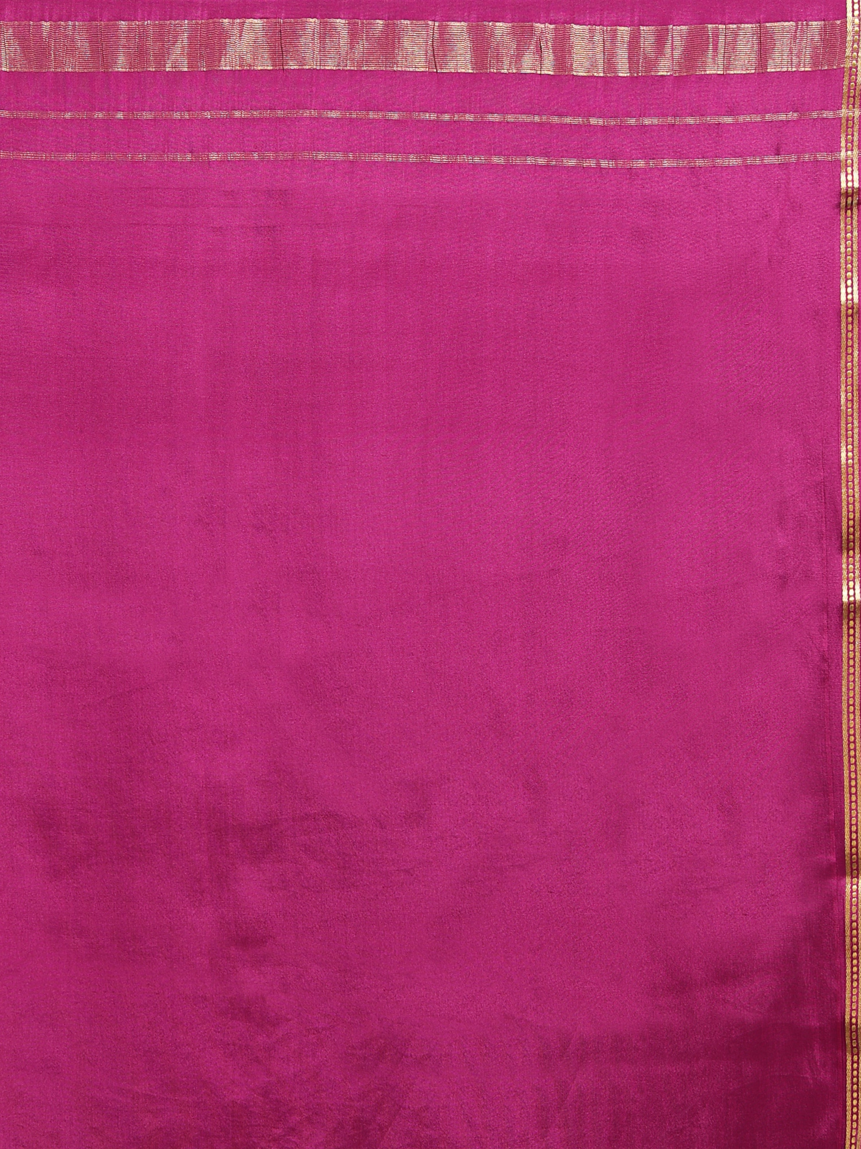 Close up of rani pink silk with narrow gold zari border and horizontal stripe zari pallu detailing