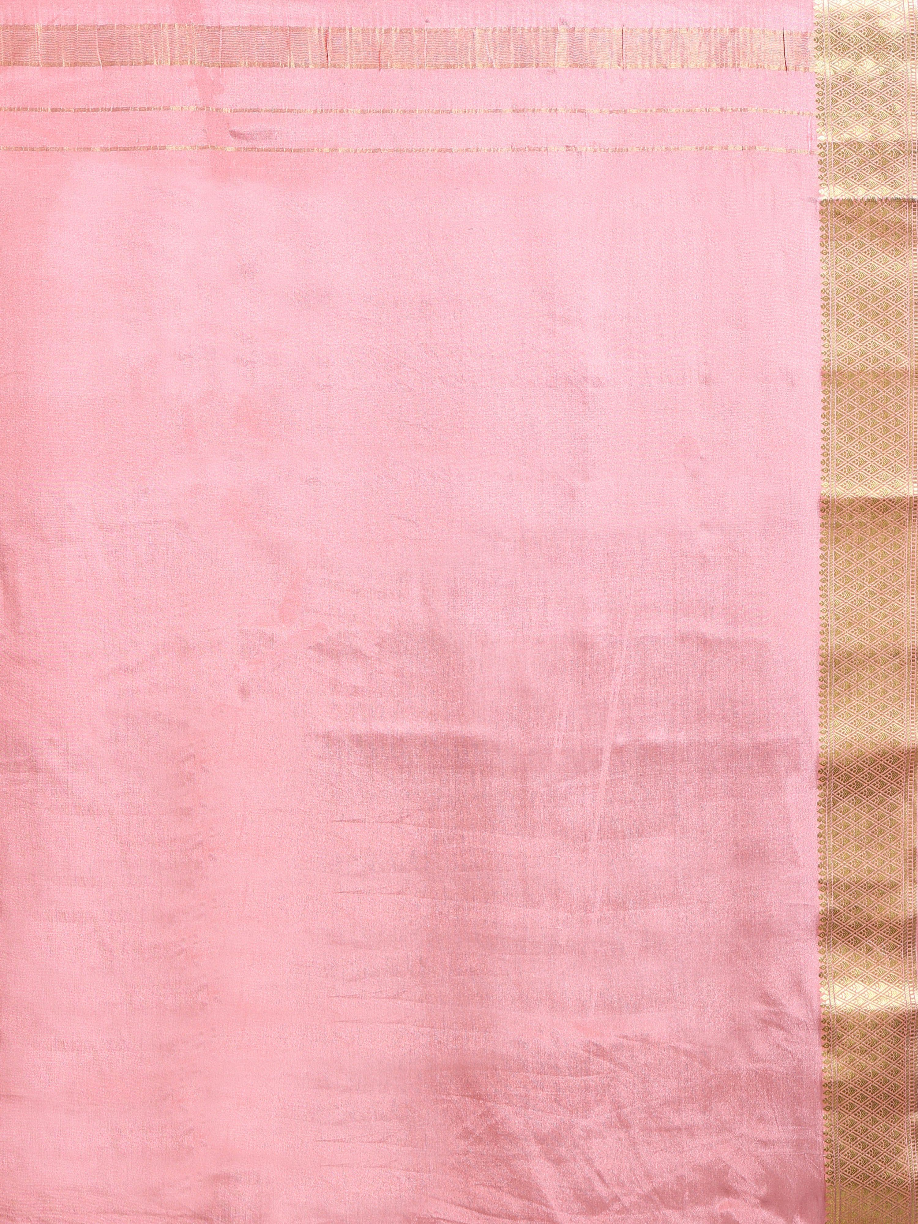 Close up of peach/salmon silk body with fine gold zari motifs and wide antique gold zari geometric border
