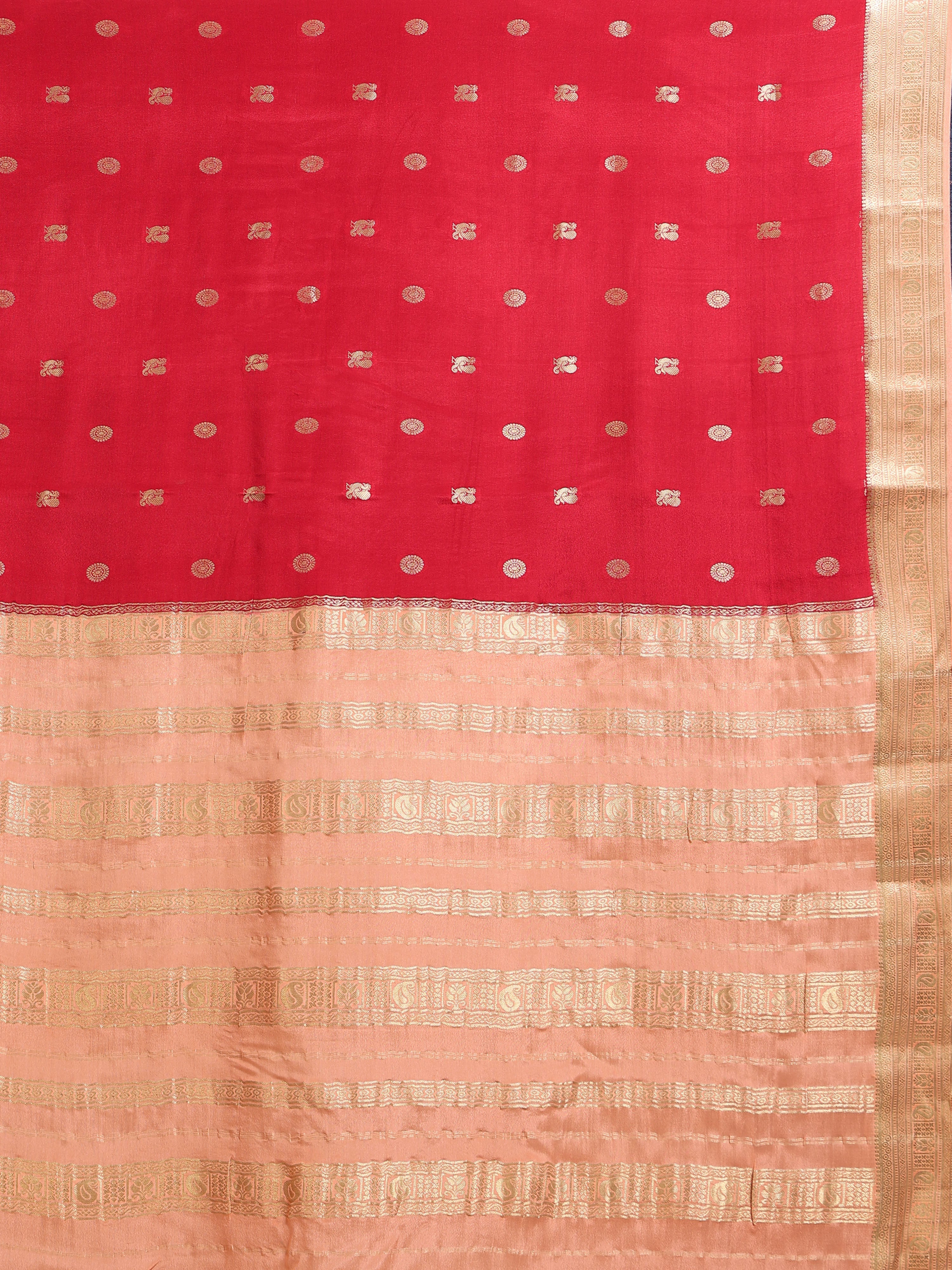 Close up of crimson red body with large oval gold zari medallion buttas and peach pallu with gold zari block bands