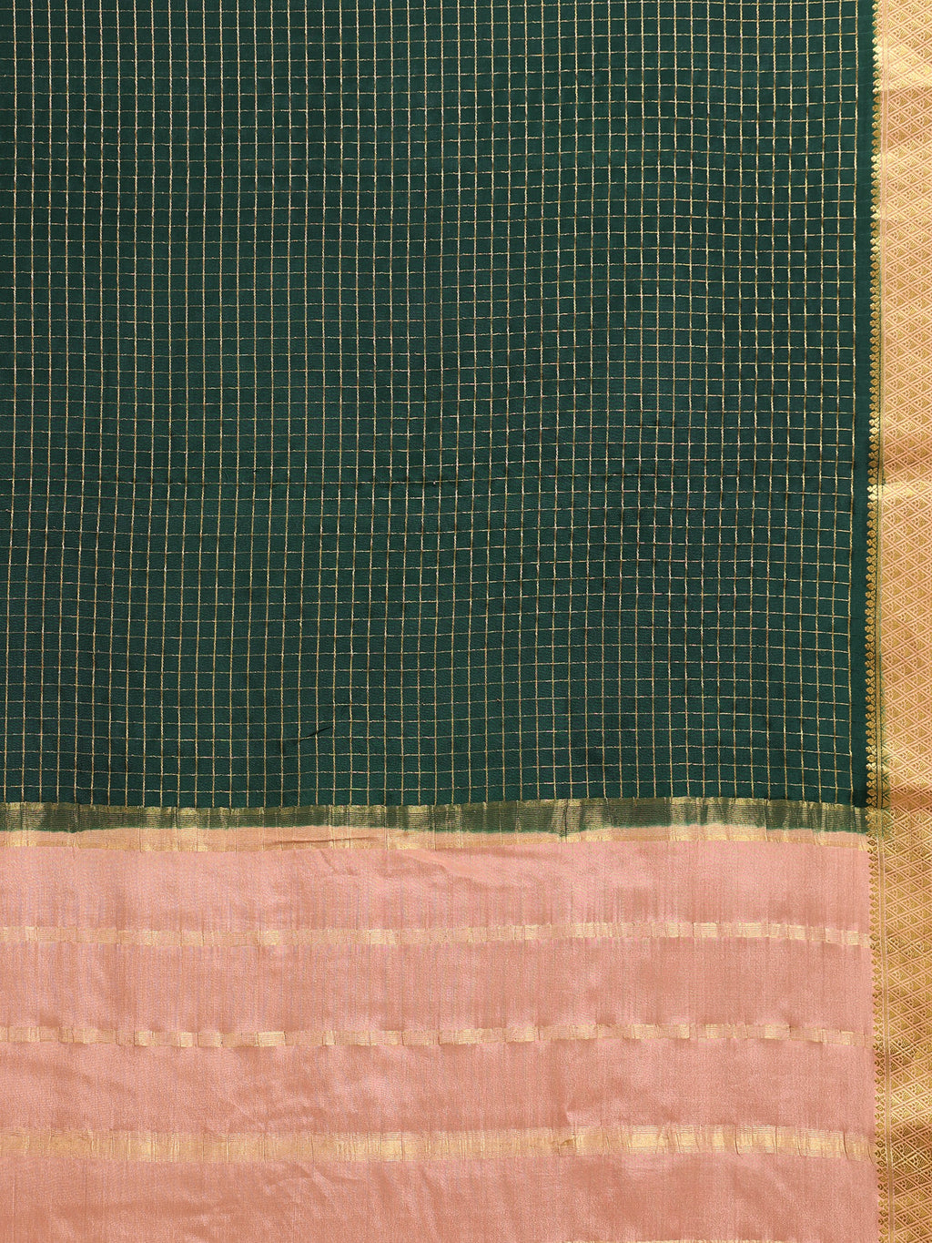 Close up of bottle green body with fine gold zari check grid and soft peach pallu with gold zari block motifs