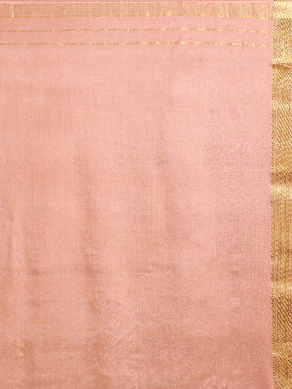 Close up of soft peach pallu with subtle gold zari rectangular block motifs and wide antique gold zari geometric border
