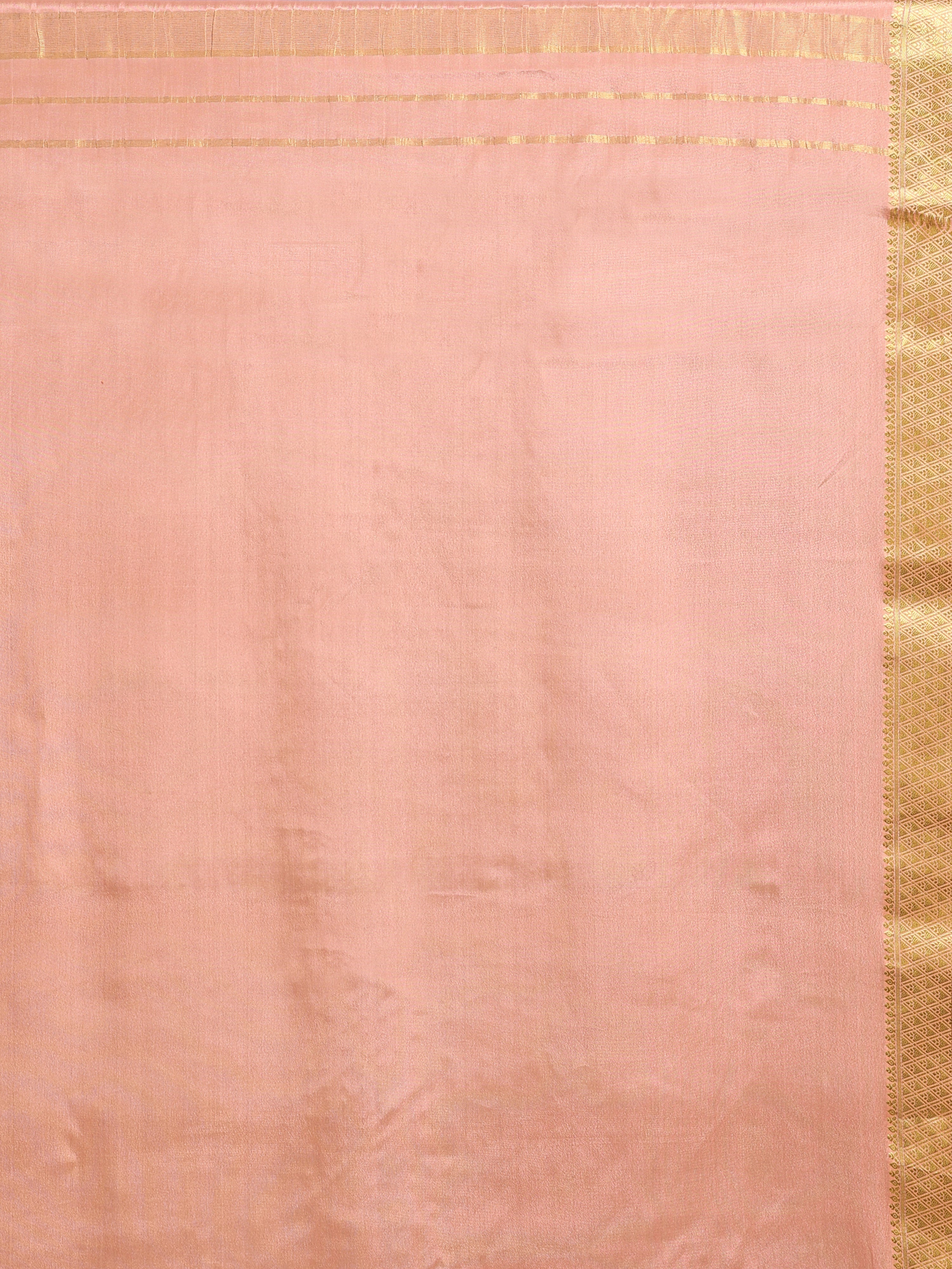 Close up of soft peach pallu with subtle gold zari rectangular block motifs and wide antique gold zari geometric border