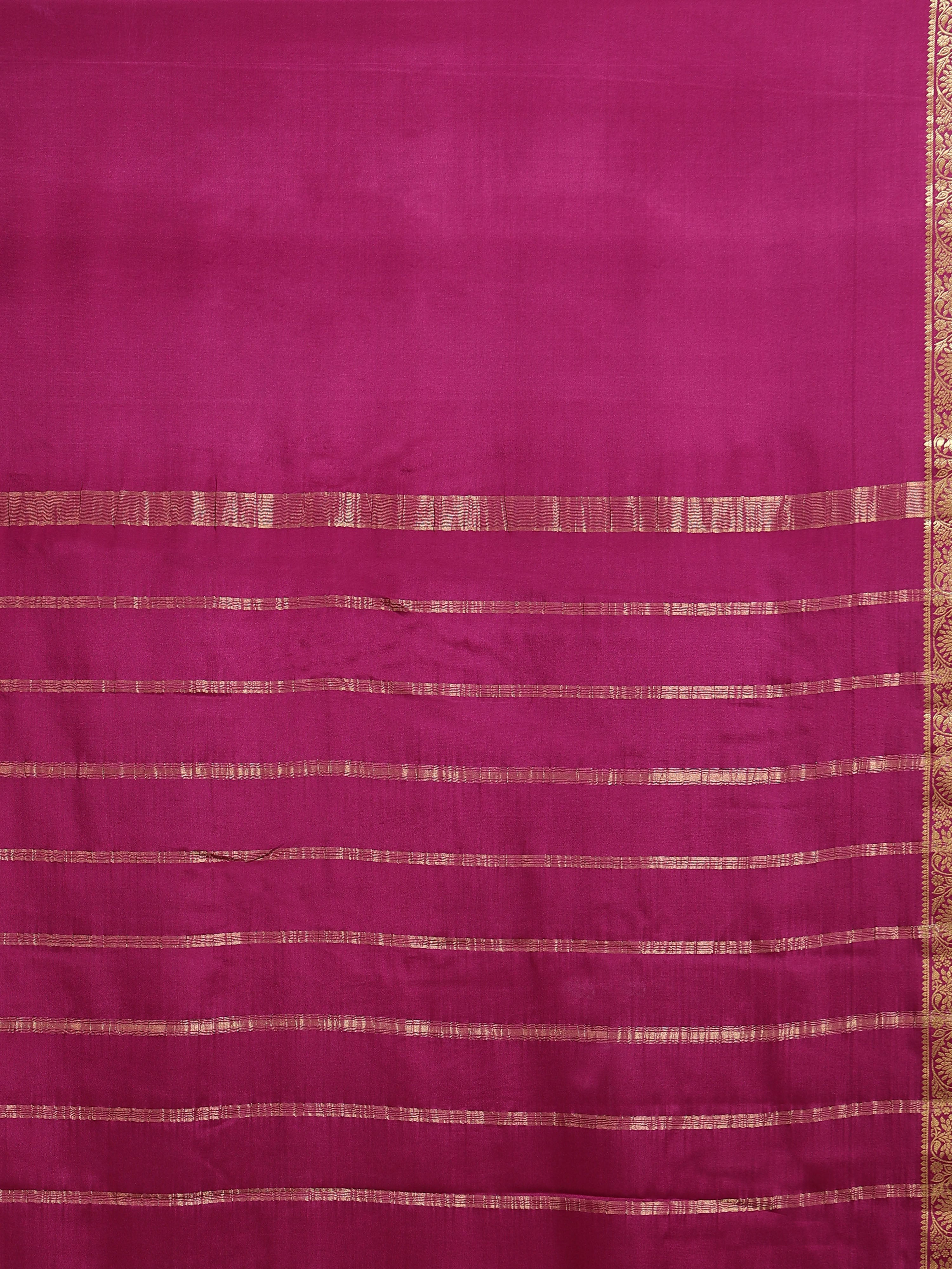 Close up of deep magenta pallu with horizontal antique gold zari rectangular block stripe bands