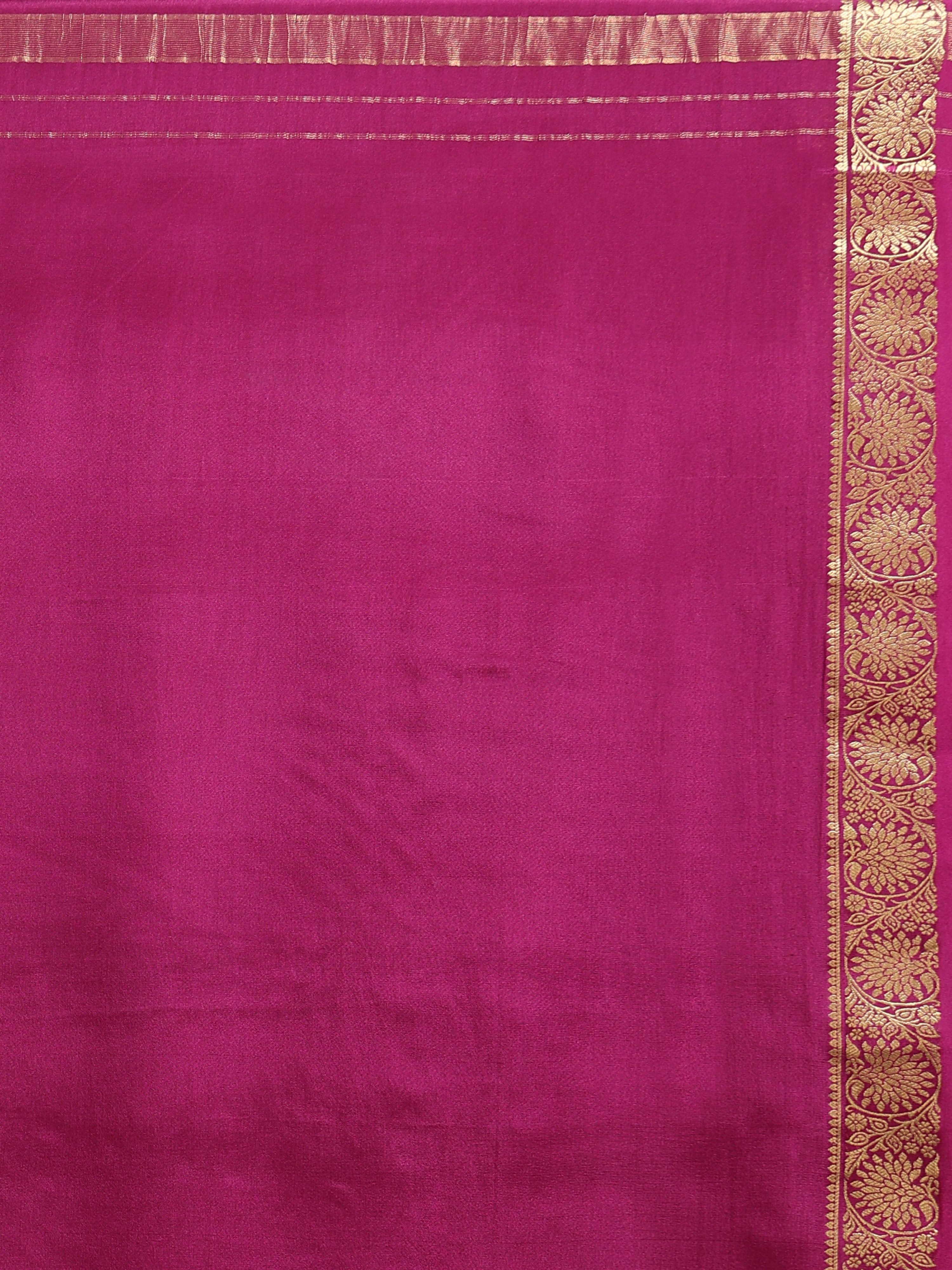 Close up of wide antique gold zari border with dense repeating circular floral medallion motifs on wine pink silk