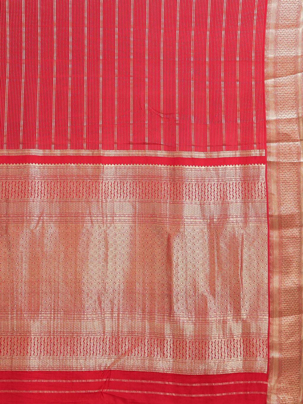 Close up of coral red body with dense fine vertical gold zari stripes and all-over gold jaal pallu with wave border bands