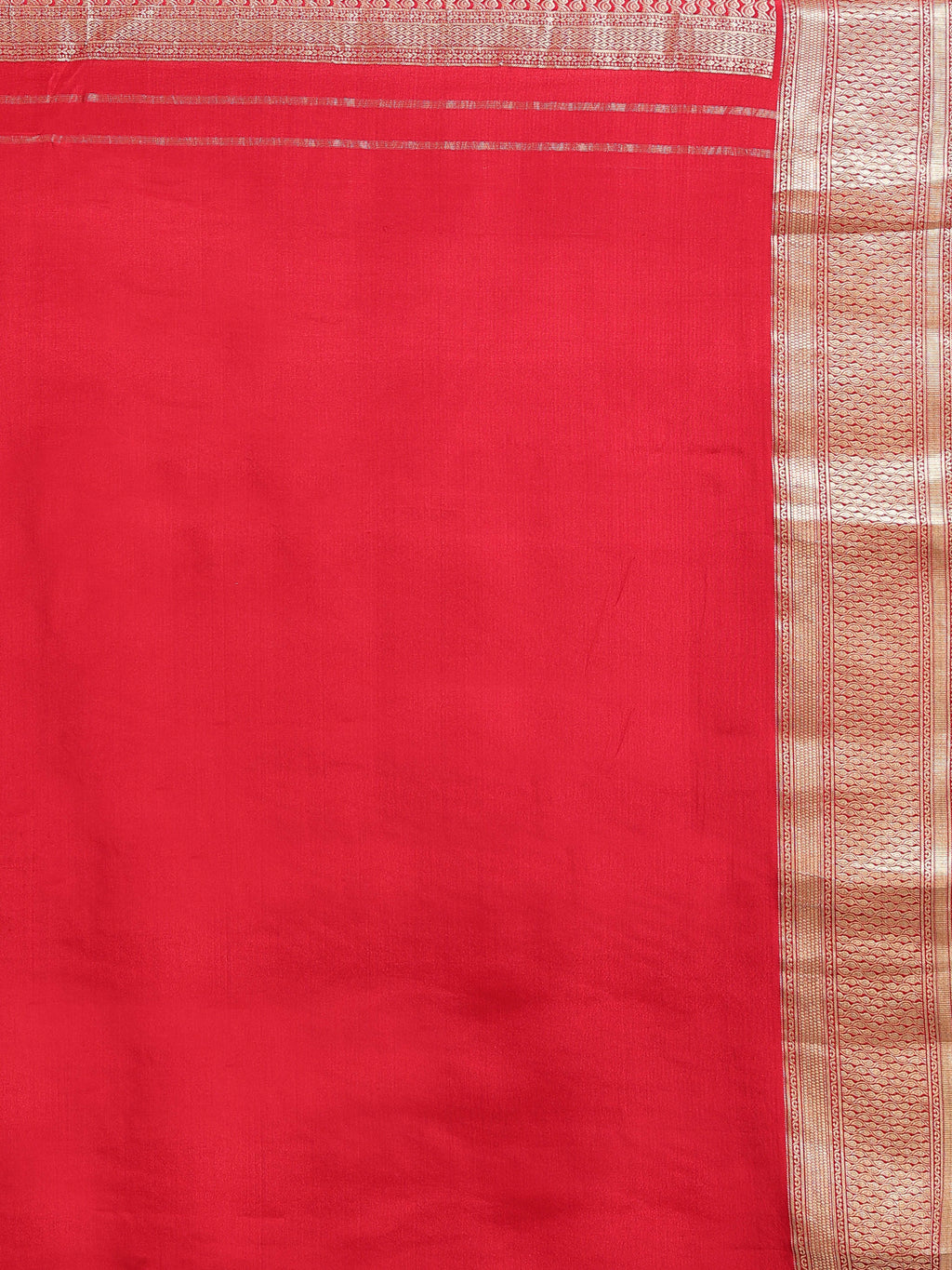 Close up of coral red silk body with fine gold zari vertical stripes and narrow multi-band antique gold zari geometric border
