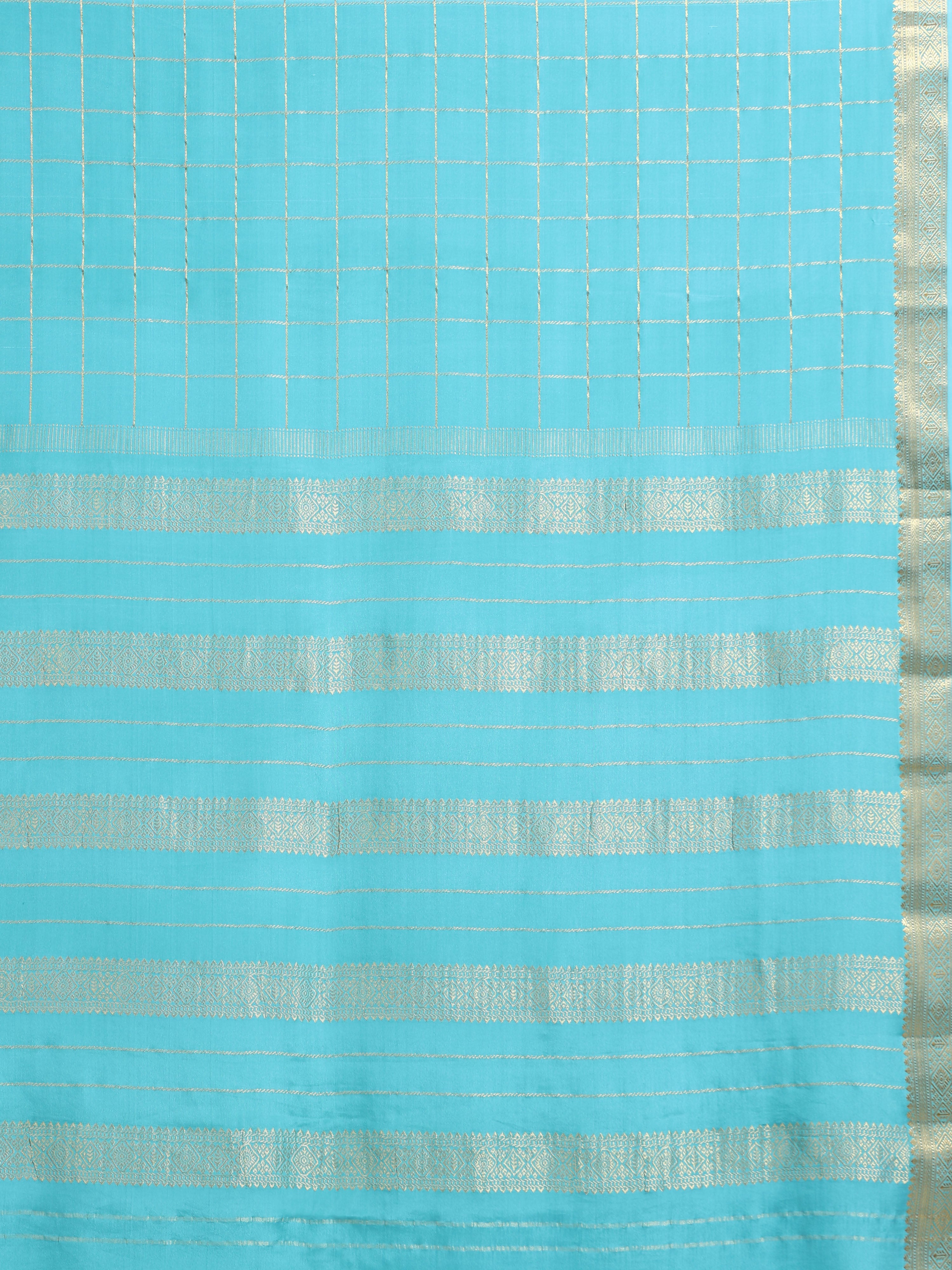 Close up of turquoise body with large gold zari check grid and alternating gold zari geometric floral stripe pallu bands