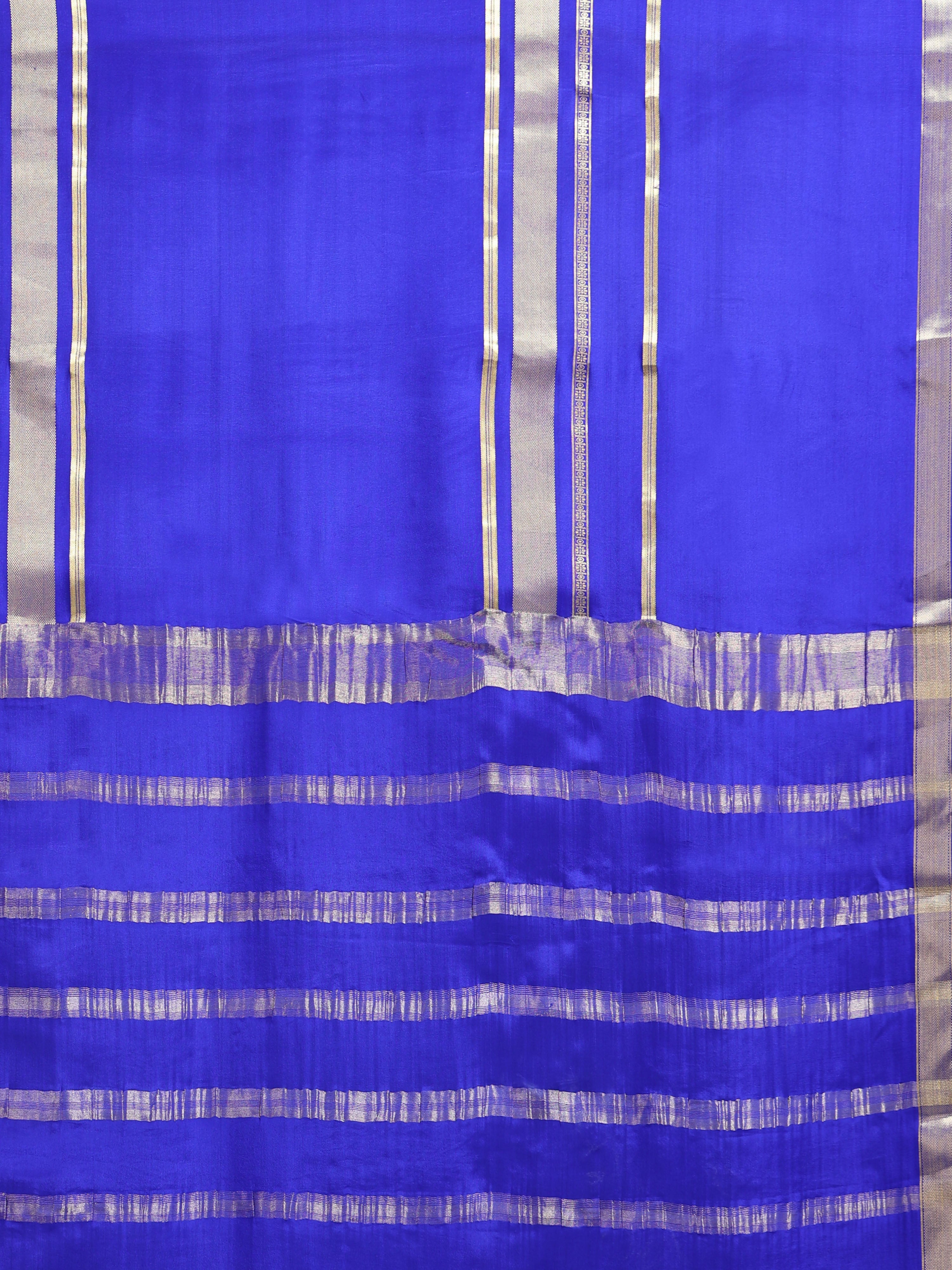 Close up of royal blue body with sparse vertical silver zari stripes and wide horizontal silver zari stripe pallu bands
