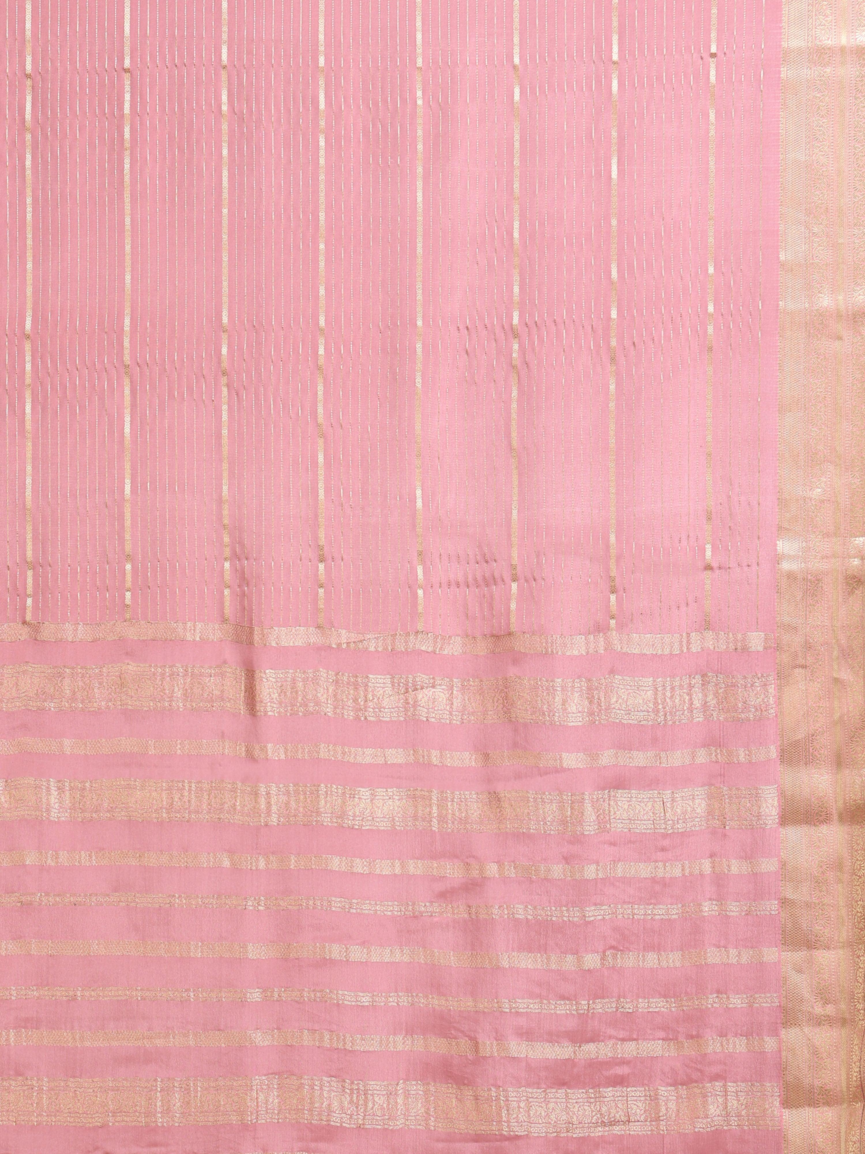 Close up of soft baby pink body with scattered gold zari buttas and large gold zari check pallu with dense vertical stripe upper pallu
