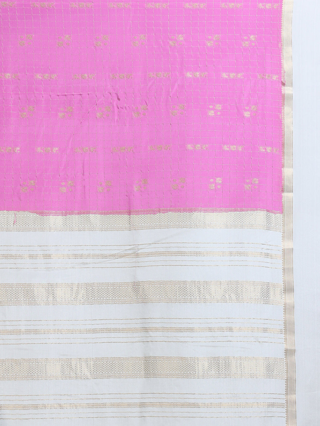 Close up of hot pink body with fine gold zari check grid and tiny buttas; white pallu with horizontal gold zari stripe bands