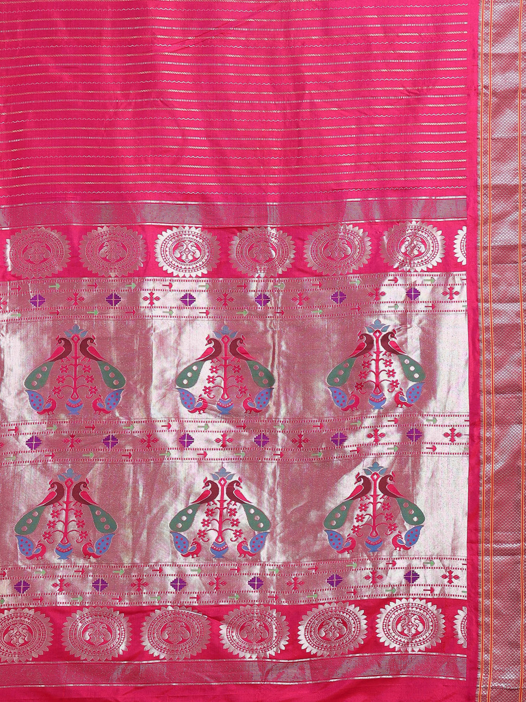 Close up of hot pink body with dense horizontal silver zari stripes and multicolour Paithani peacock pairs on silver zari pallu ground