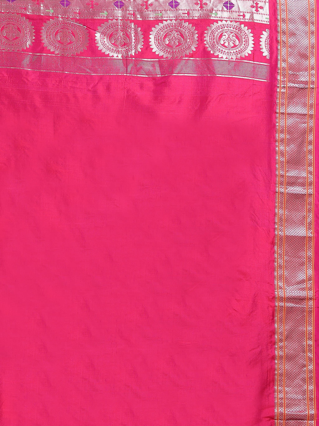 Close up of plain hot pink silk blouse piece with narrow multi-band silver zari circular medallion border and Paithani pallu detail