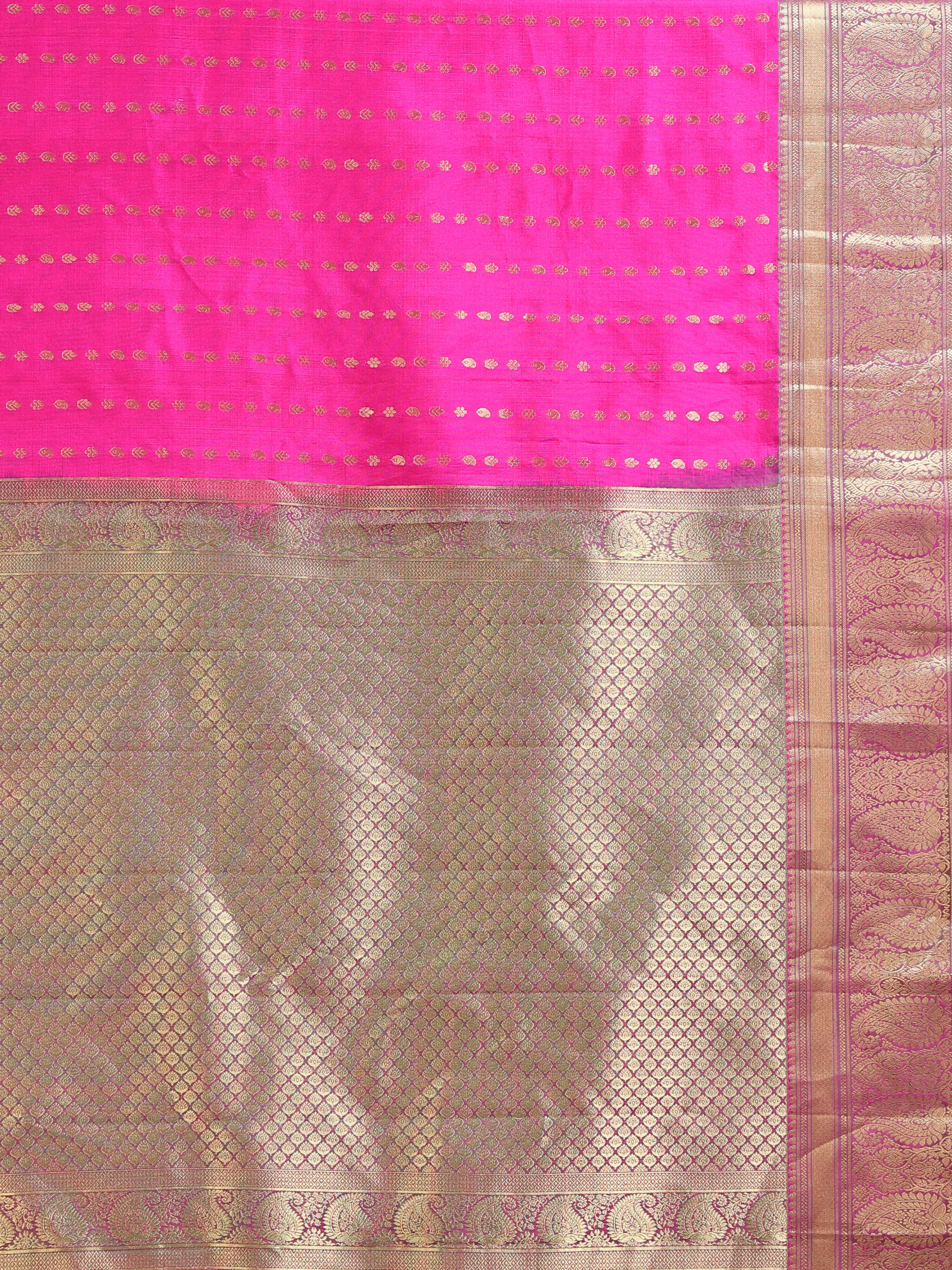 Close up of hot pink shot silk body with rows of gold zari oval diamond buttas and all-over antique gold jaal pallu
