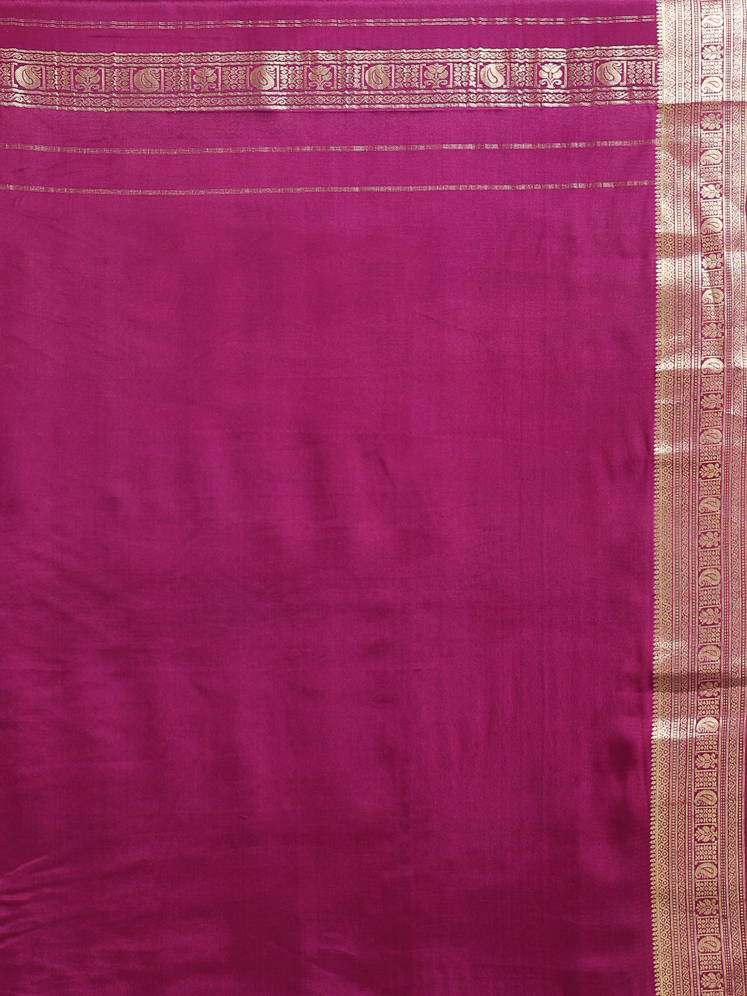 Close up of plain deep magenta silk blouse piece with narrow multi-band antique gold zari peacock paisley border