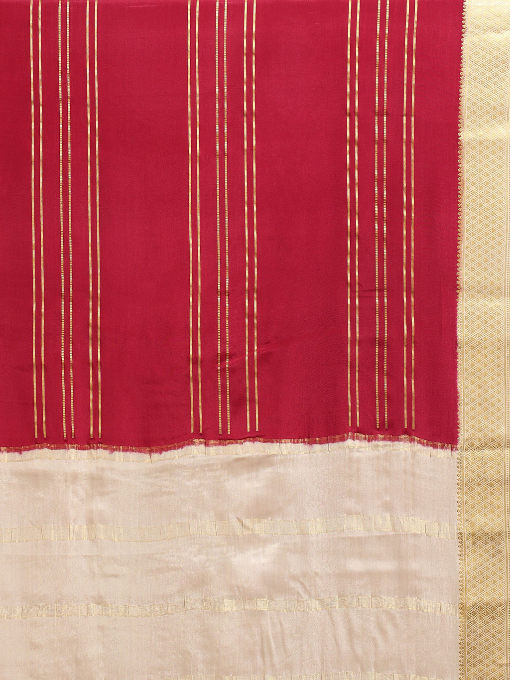 Close up of crimson red body with clustered vertical gold zari stripe lines and plain cream pallu with wide antique gold zari diamond lattice border
