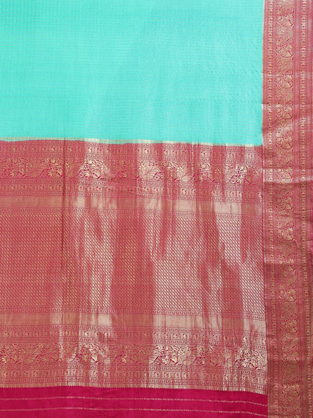Close up of plain aqua green silk body and deep magenta pallu with vertical antique gold zari geometric stripe columns and floral scrollwork bands