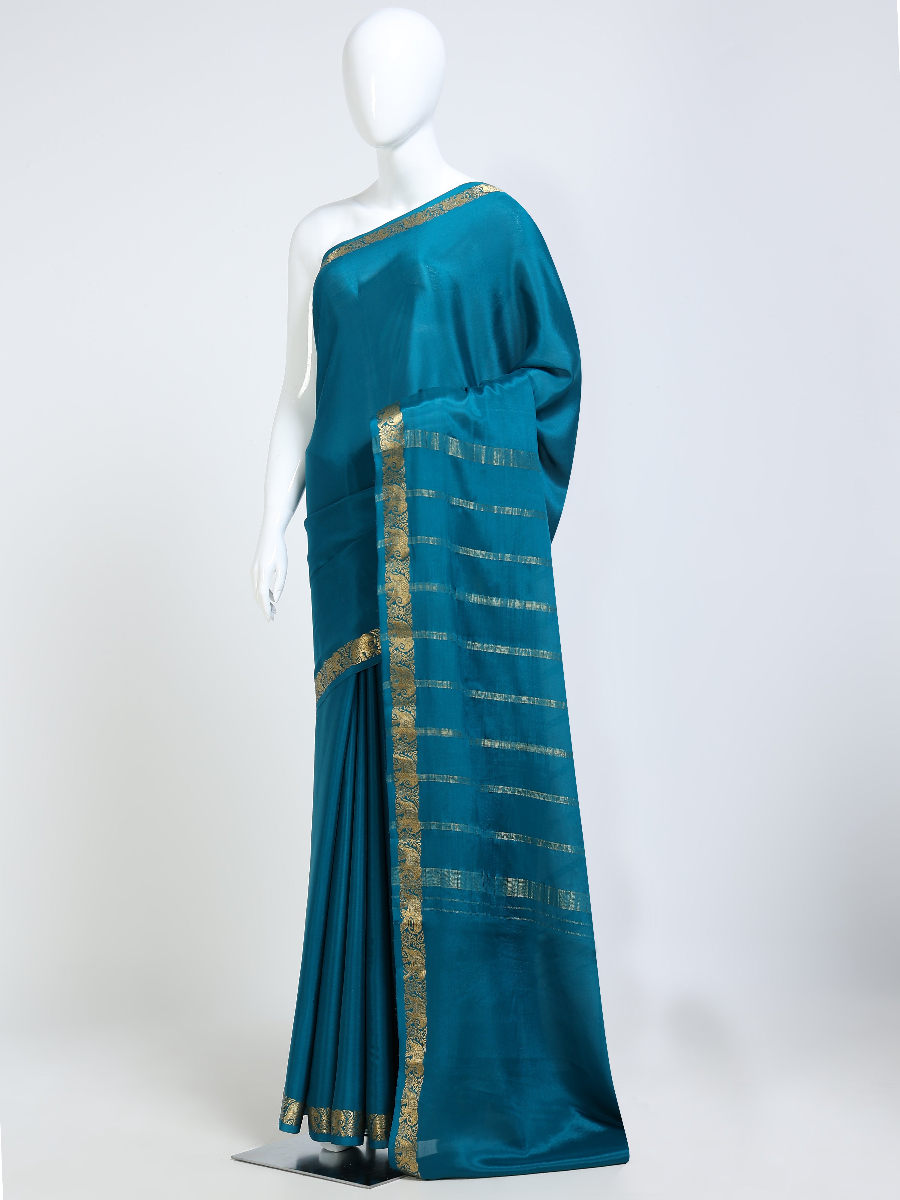 Teal Peacock Blue Mysore Crepe Pure Silk Saree with gold zari stripe pallu and elephant motif border - mannequin side view