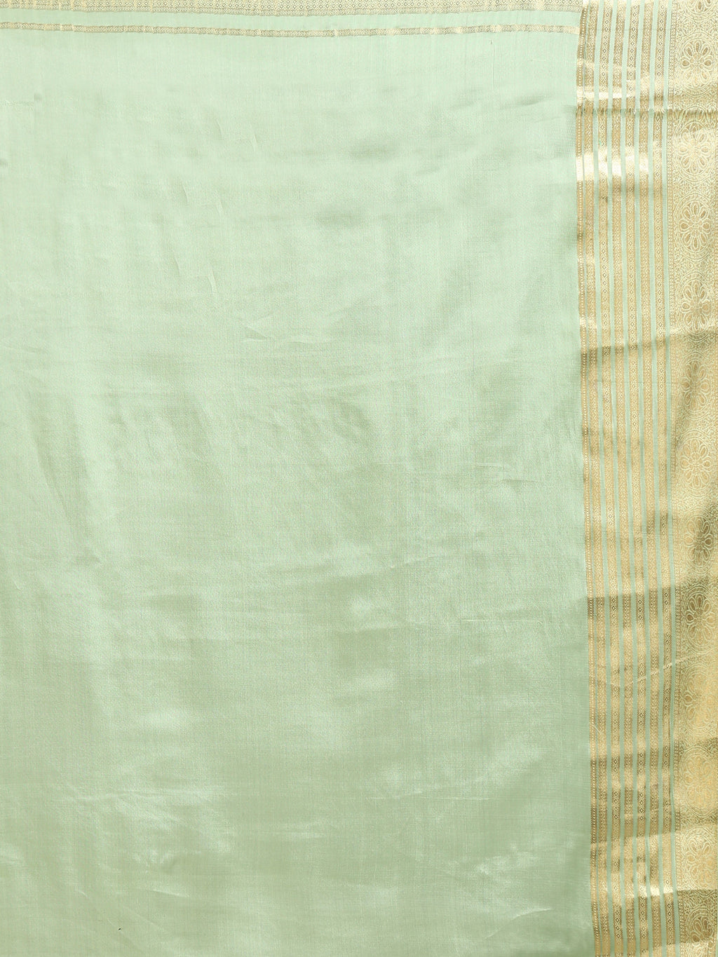 Close up of plain soft mint celadon green silk blouse piece with wide antique gold zari multi-band vertical stripe border and floral scrollwork