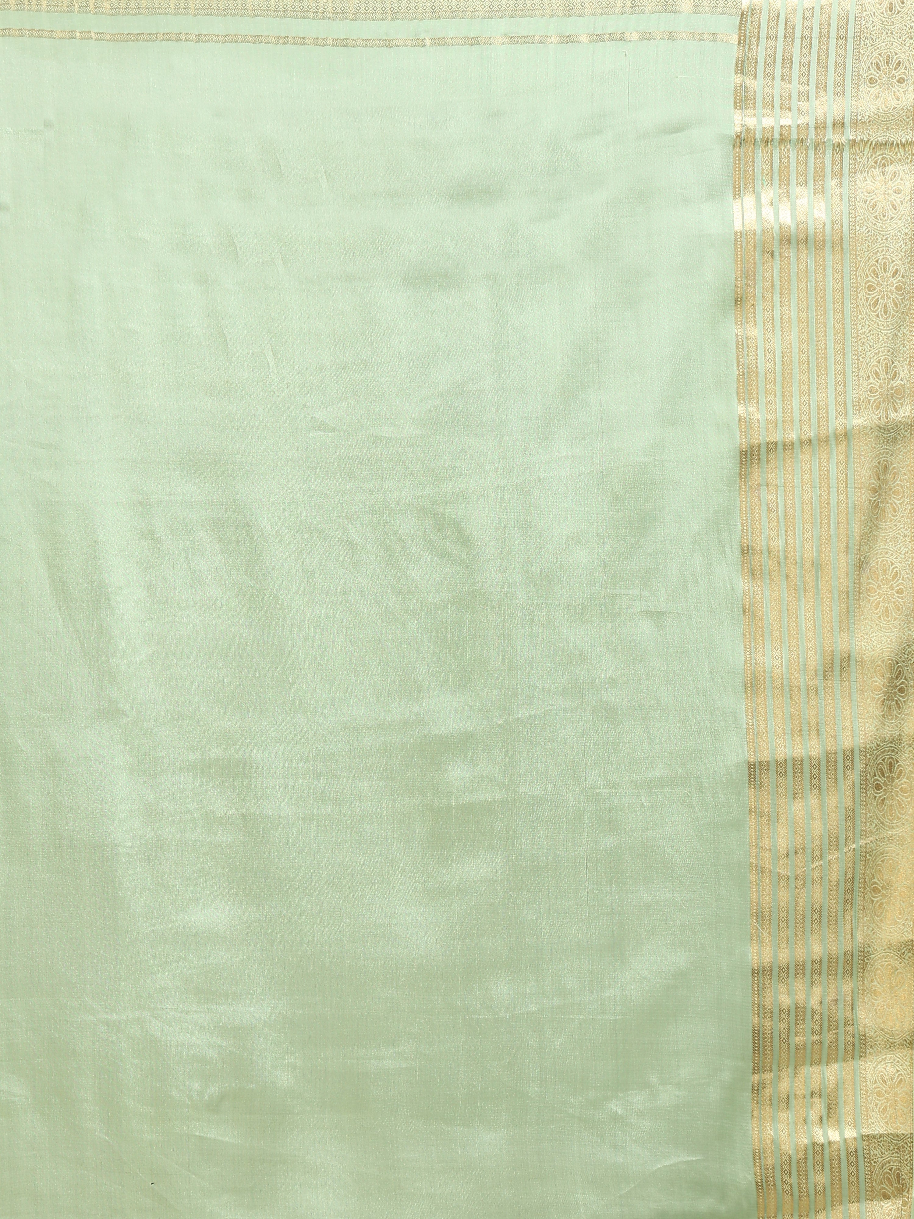 Close up of plain soft mint celadon green silk blouse piece with wide antique gold zari multi-band vertical stripe border and floral scrollwork