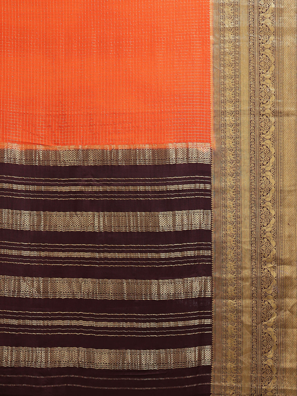 Close up of orange body with fine gold zari check grid and dark brown pallu with gold zari stripe bands