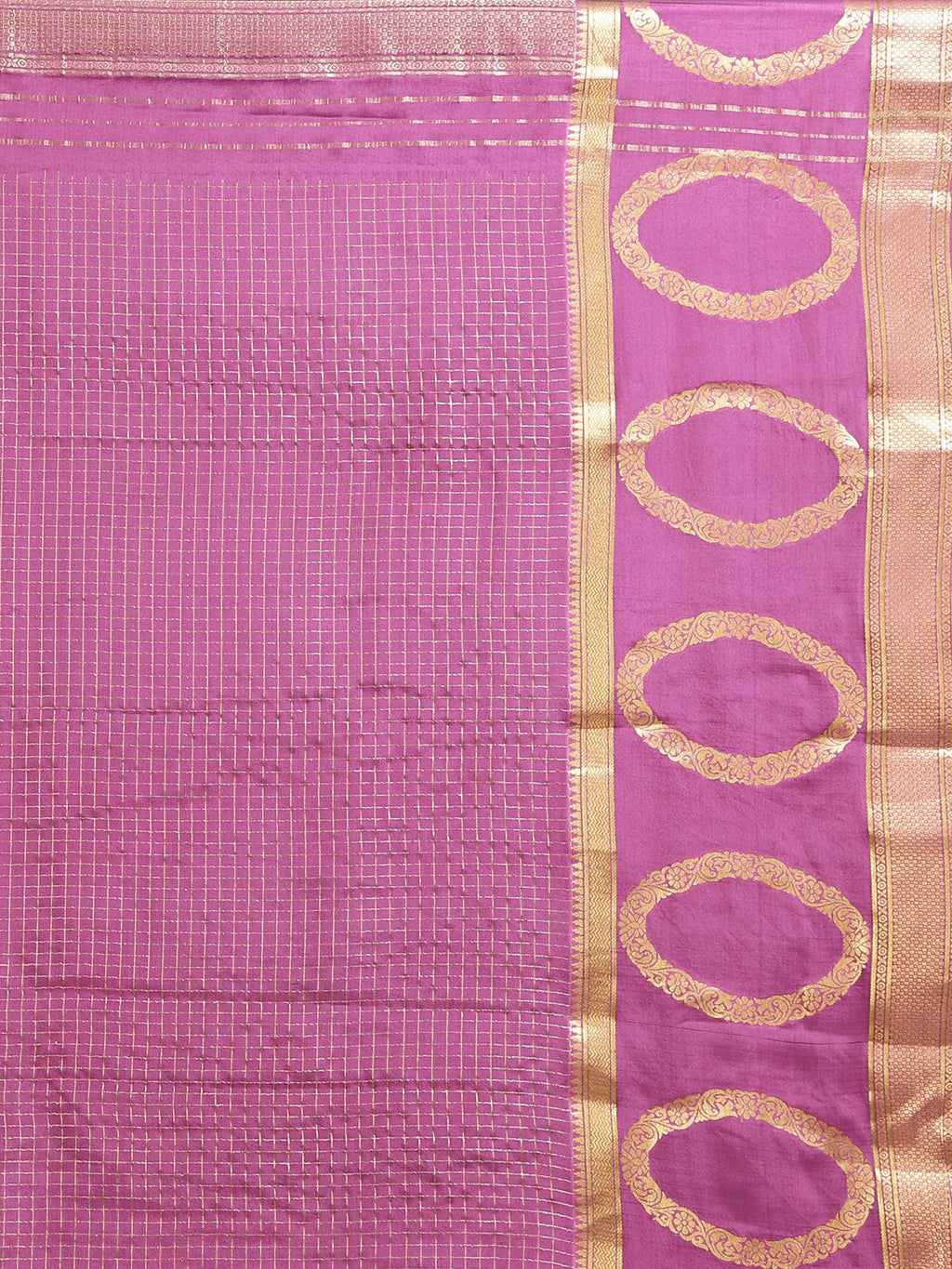 Close up of distinctive large oval motif gold zari border on mauve pink silk saree