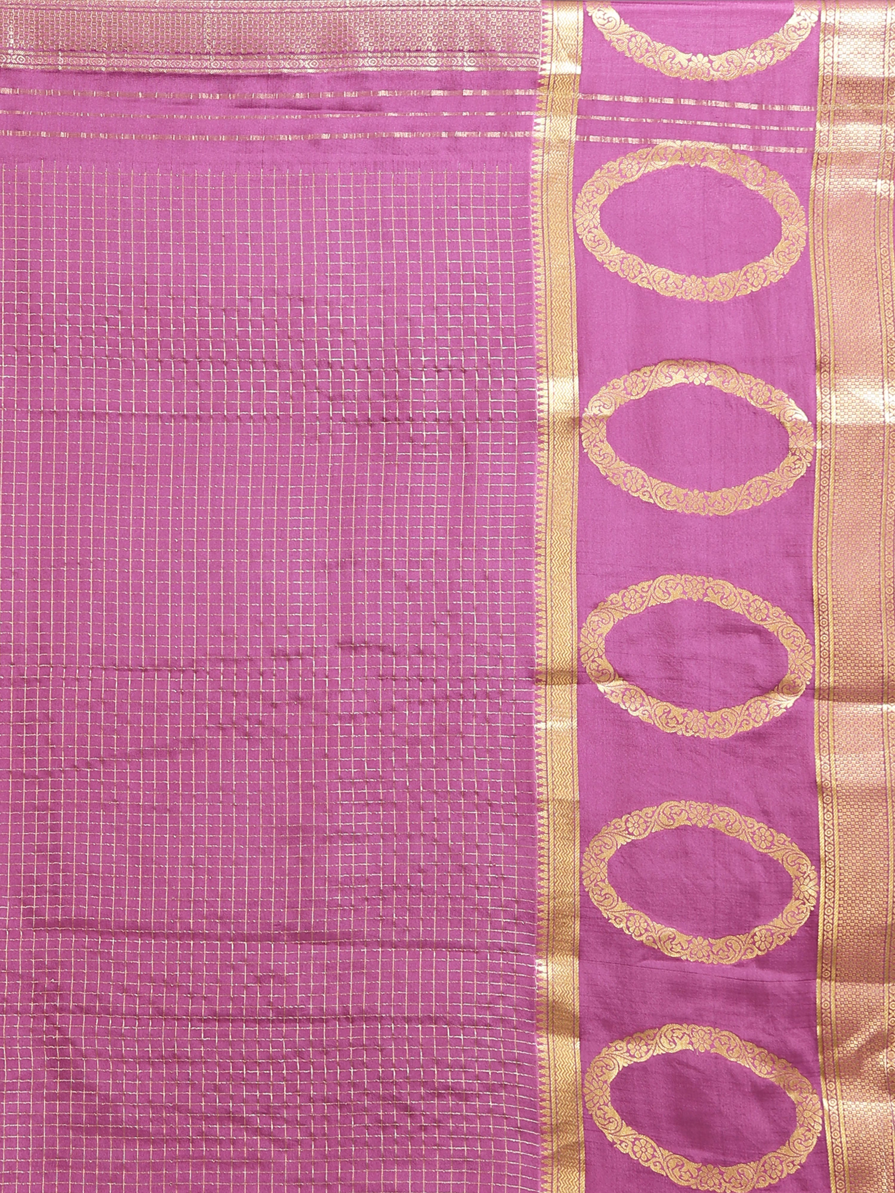Close up of distinctive large oval motif gold zari border on mauve pink silk saree