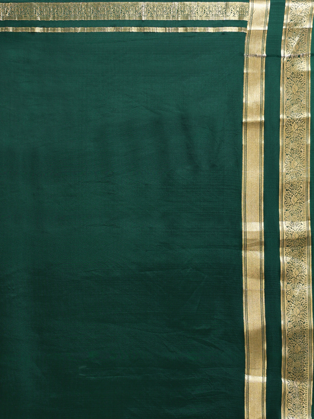 Close up of deep bottle green blouse piece with wide antique gold zari floral scrollwork border